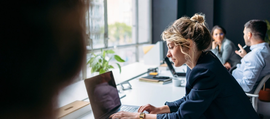 Serviced Office vs Coworking Space. Image of woman working on laptop